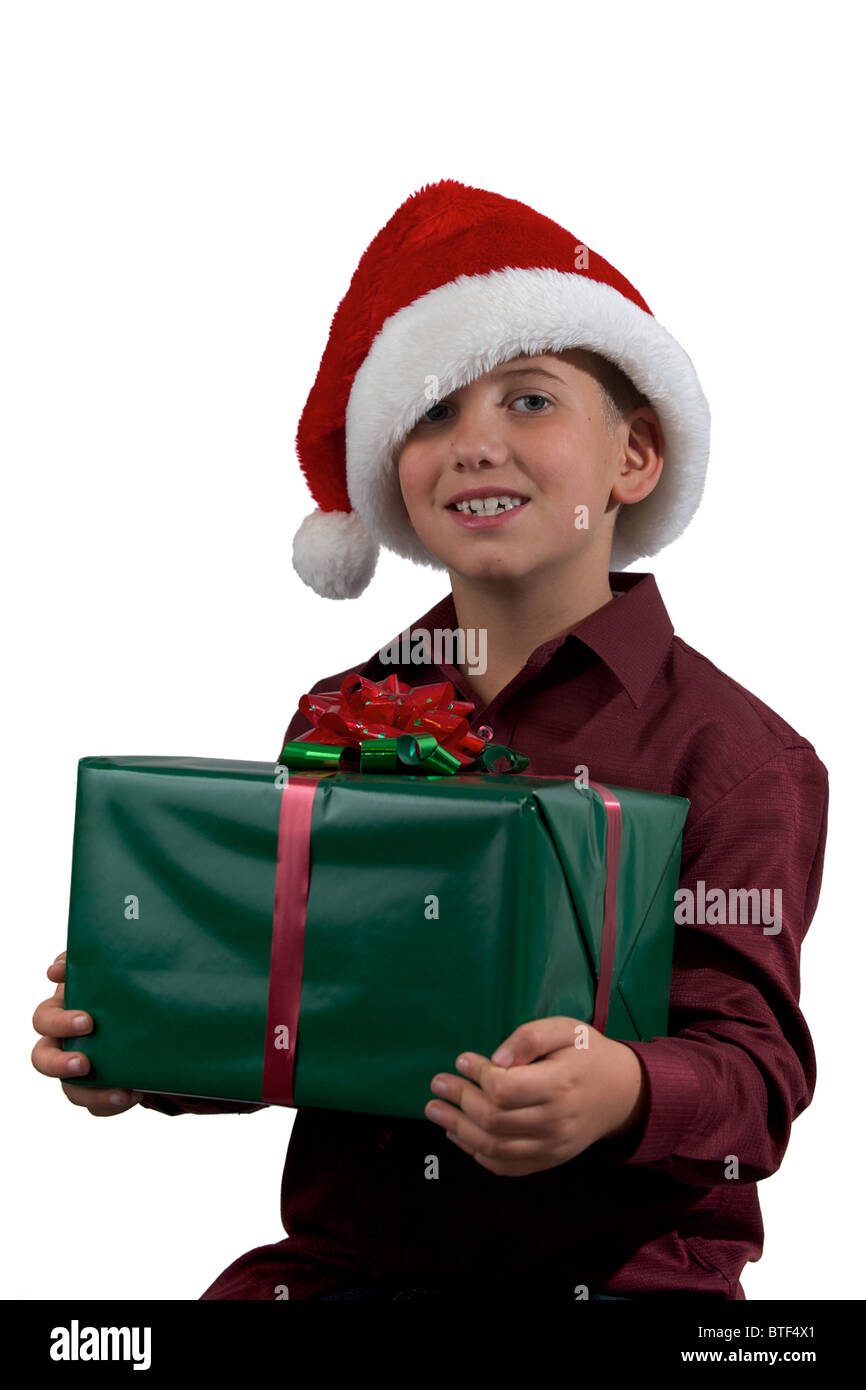 A portrait of an eight year old boy in a santa hat with a present on