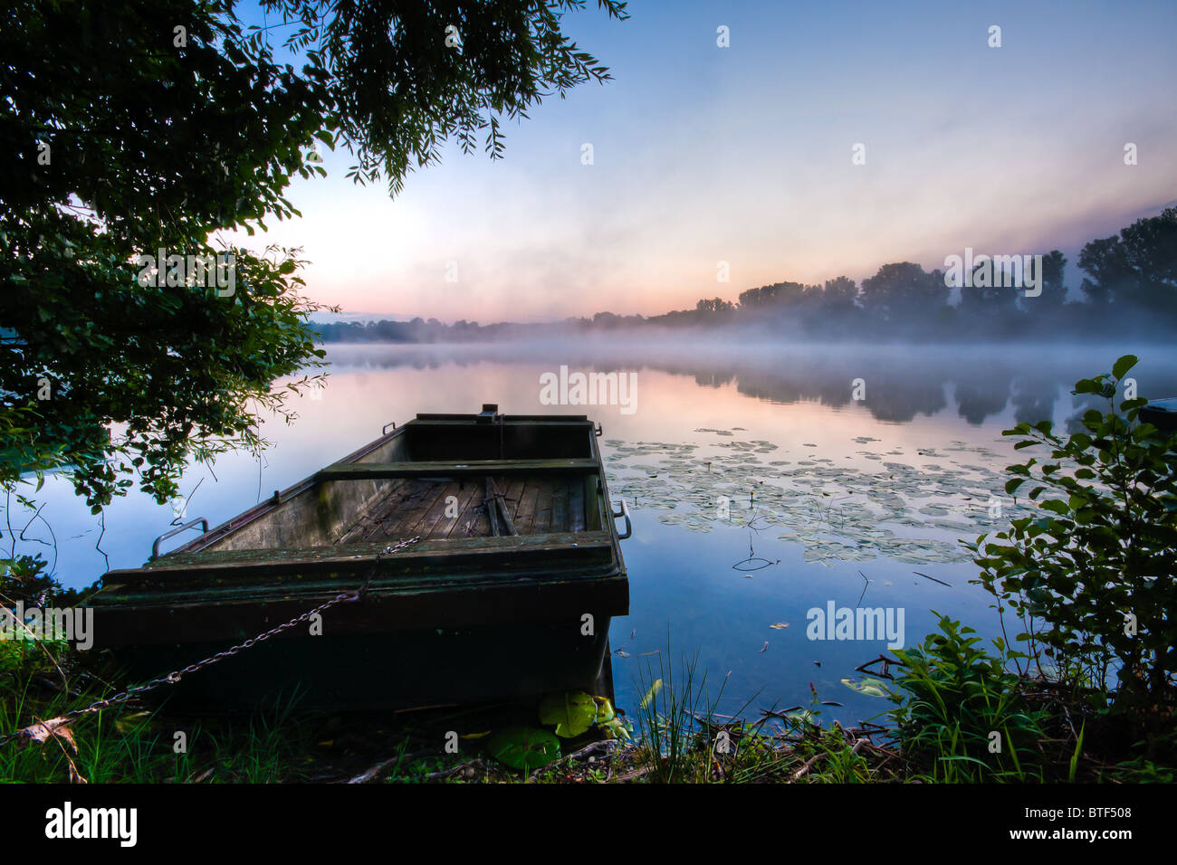 Sunrise at a lake with boats Stock Photo