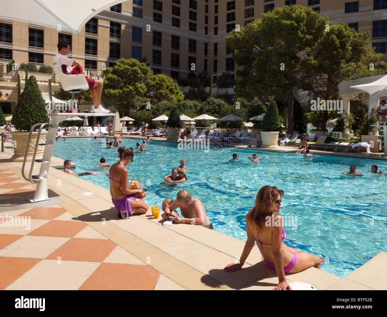 guests enjoying the swimmng pool at the luxury Bellagio Hotel, Las Vegas USA Stock Photo