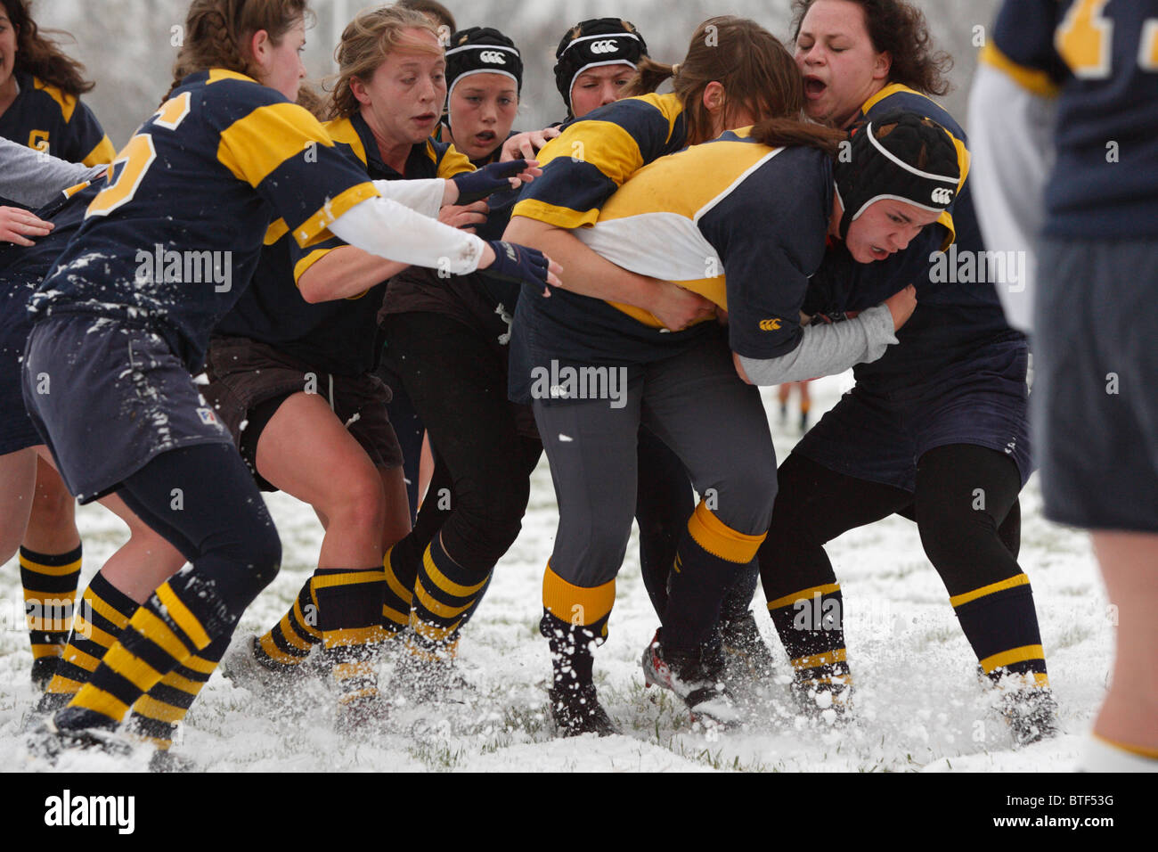 A Naval Academy ball carrier is tackled by Washington University