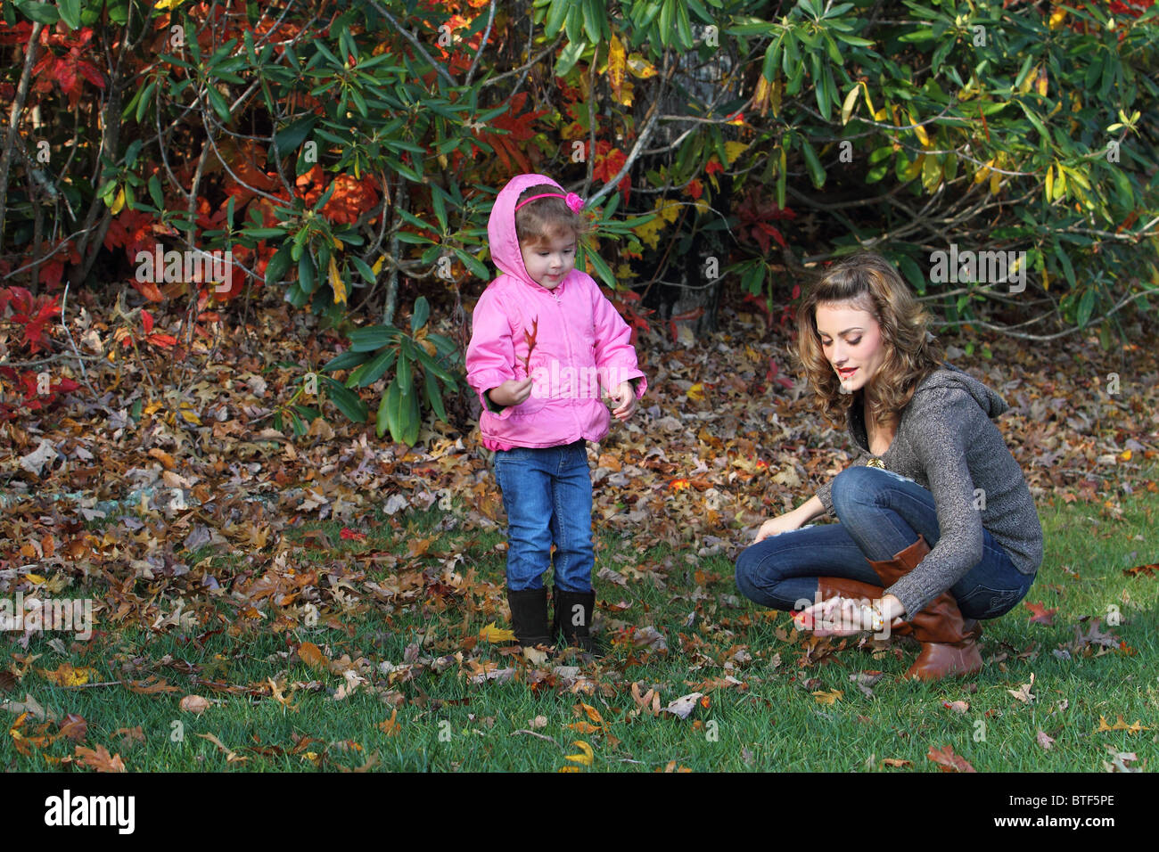Mother and daughter playing at home beautiful fall day Stock Photo
