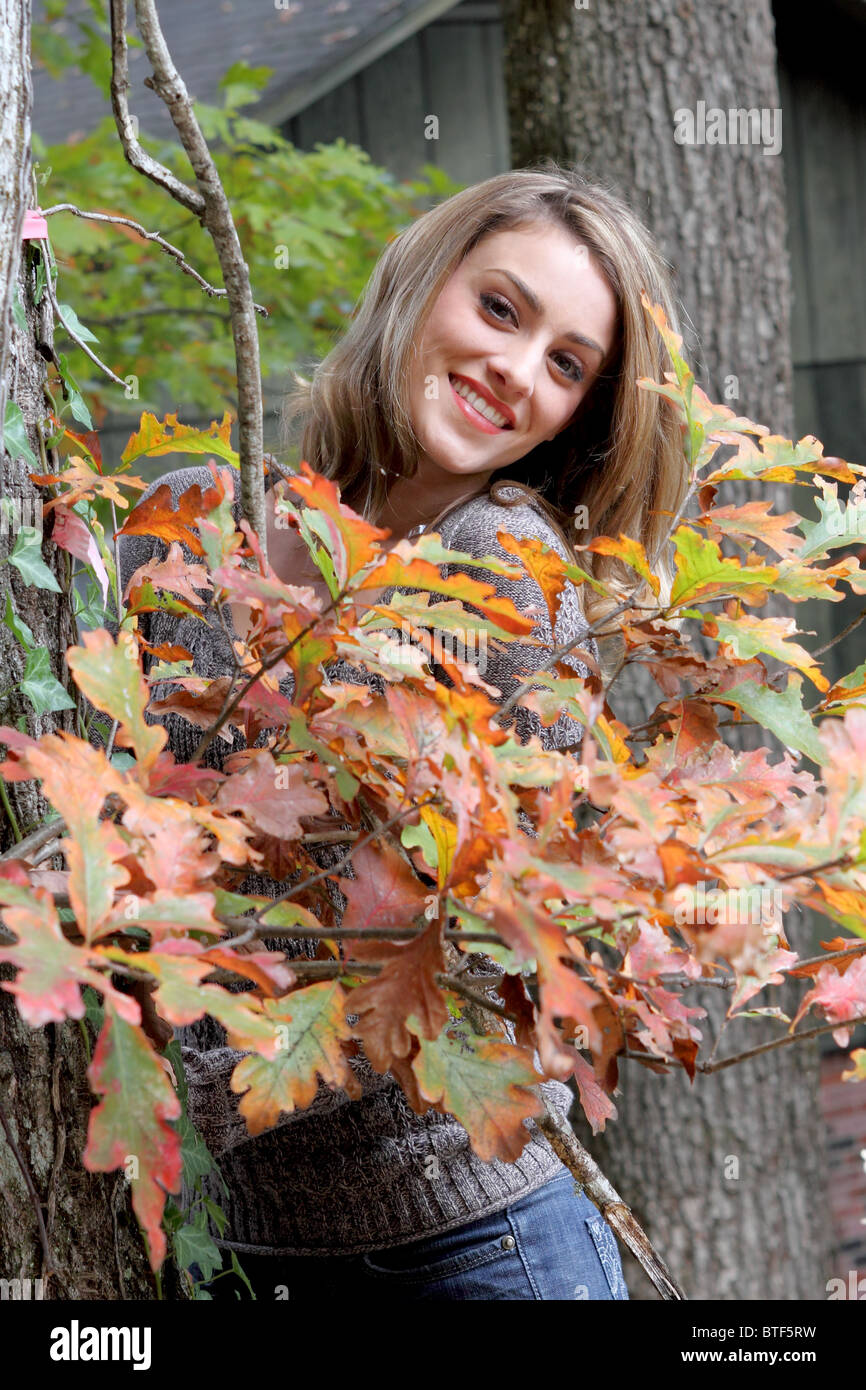 Girl with autumn orange leaves Stock Photo
