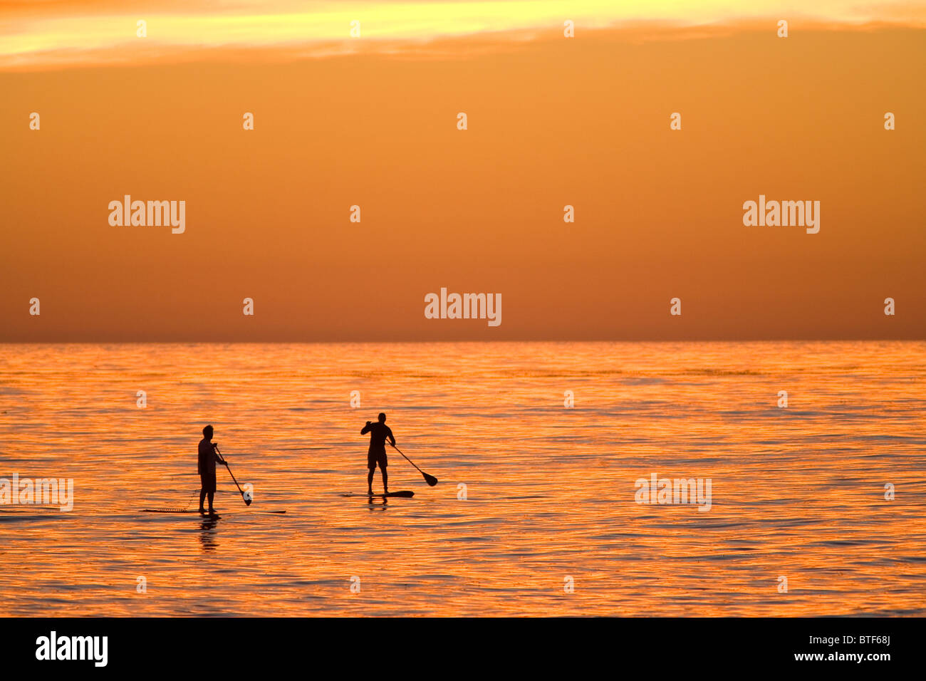 Two Stand Up Paddle Boarders at Sunset, Windnsea Beach, La Jolla, California Stock Photo