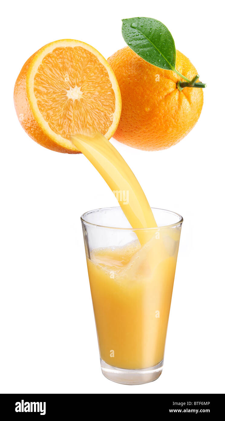 Fresh orange juice flowing from cut orange into the glass. Isolated on