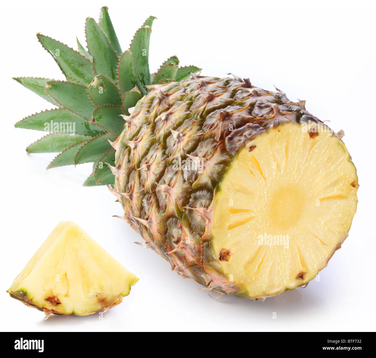 Cut ripe pineapple with rich green rosette. Isolated on a white. Stock Photo