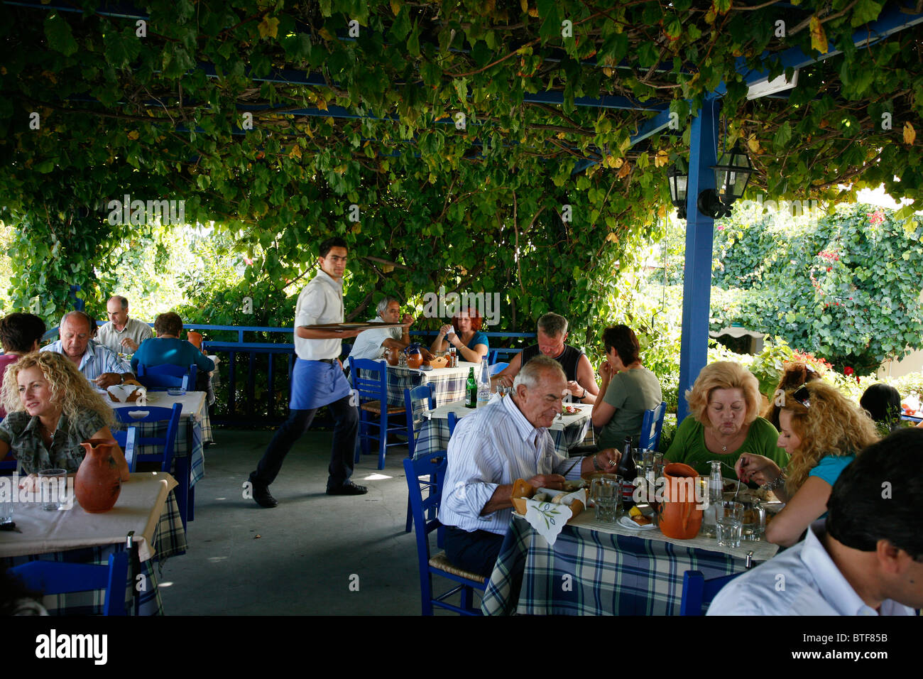 People sitting at Oromedon taverna restaurant in Zia, Kos, Greece. Stock Photo