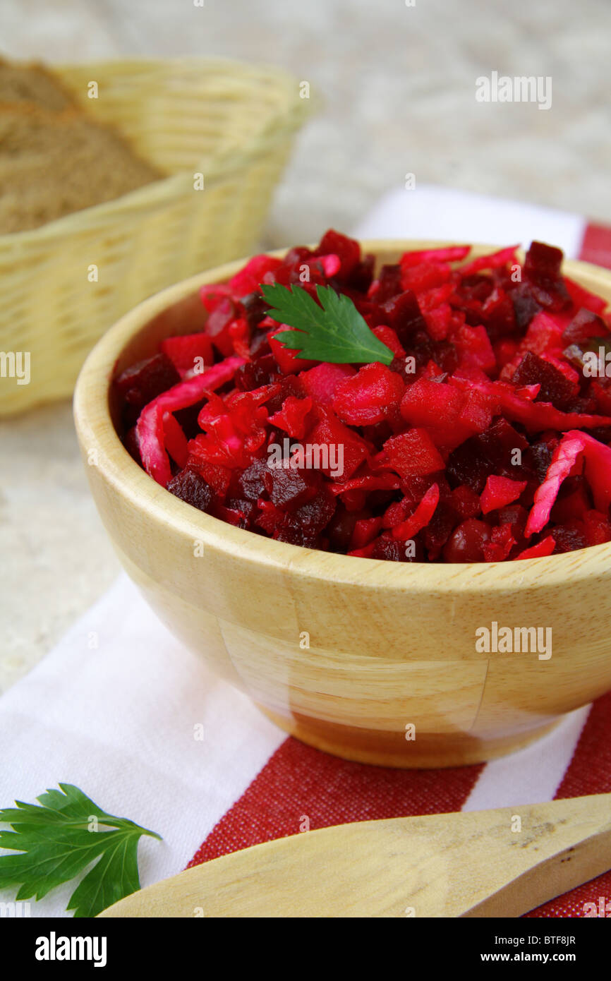 Traditional Russian beet salad in wooden bowl Stock Photo