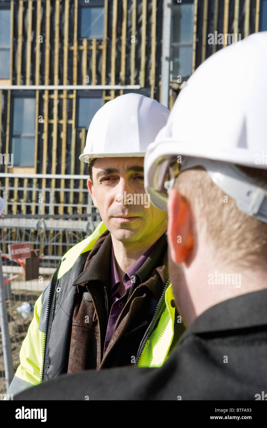 Building contractor having conversation with site foreman Stock Photo ...