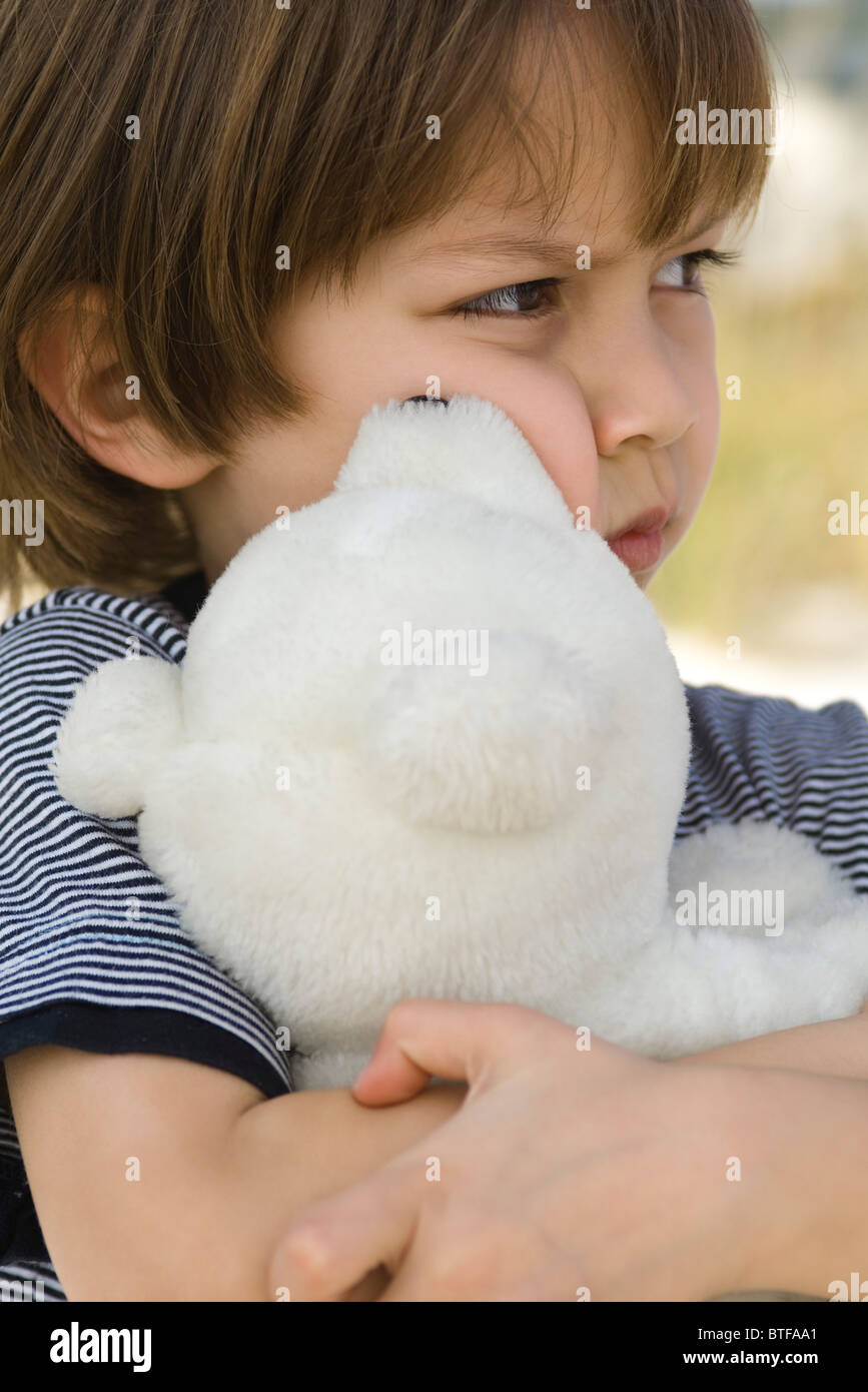 Little boy hugging teddy bear Stock Photo - Alamy