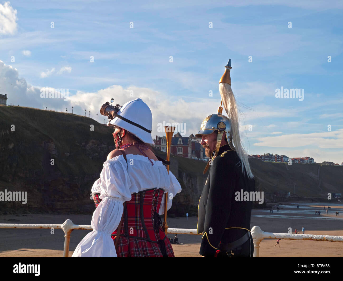 A man and woman in pseudo Military Dress on the pier at the Whitby Goth Week End 2010 Stock Photo