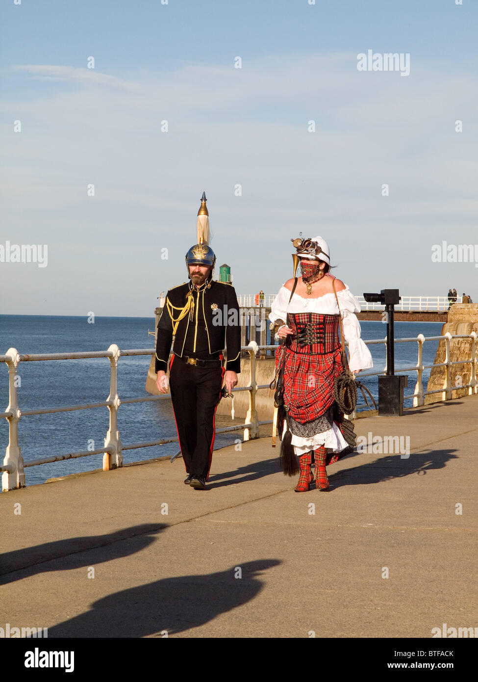 A man and woman in pseudo Military Dress on the pier at the Whitby Goth Week End 2010 Stock Photo