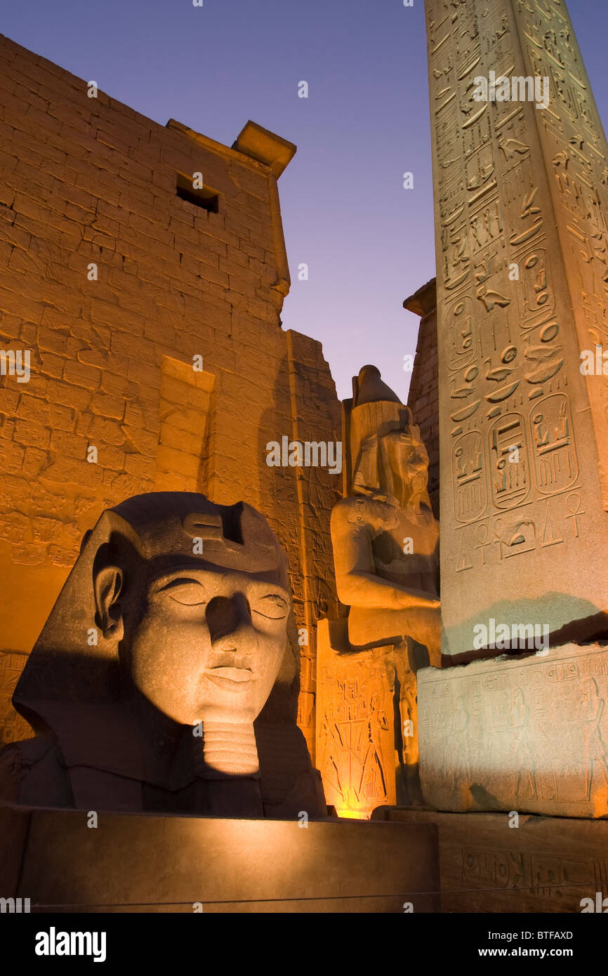 The Obelisk and Statue of Ramses 2nd lit up at night at Luxor Temple ...