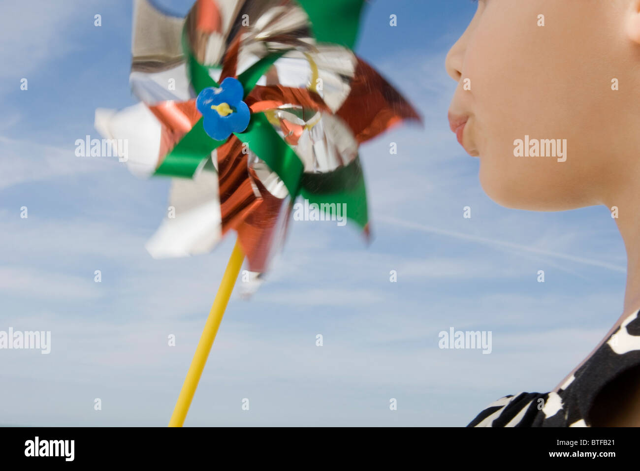 Child blowing pinwheel Stock Photo - Alamy