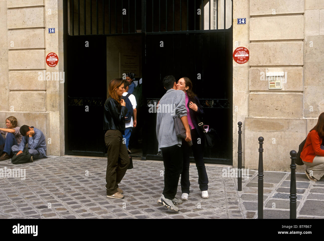 French students, French teens, French teenagers, greeting, kiss on cheek, kissing on cheek, Lycee Charlemagne, Marais District, Paris, France, Europe Stock Photo