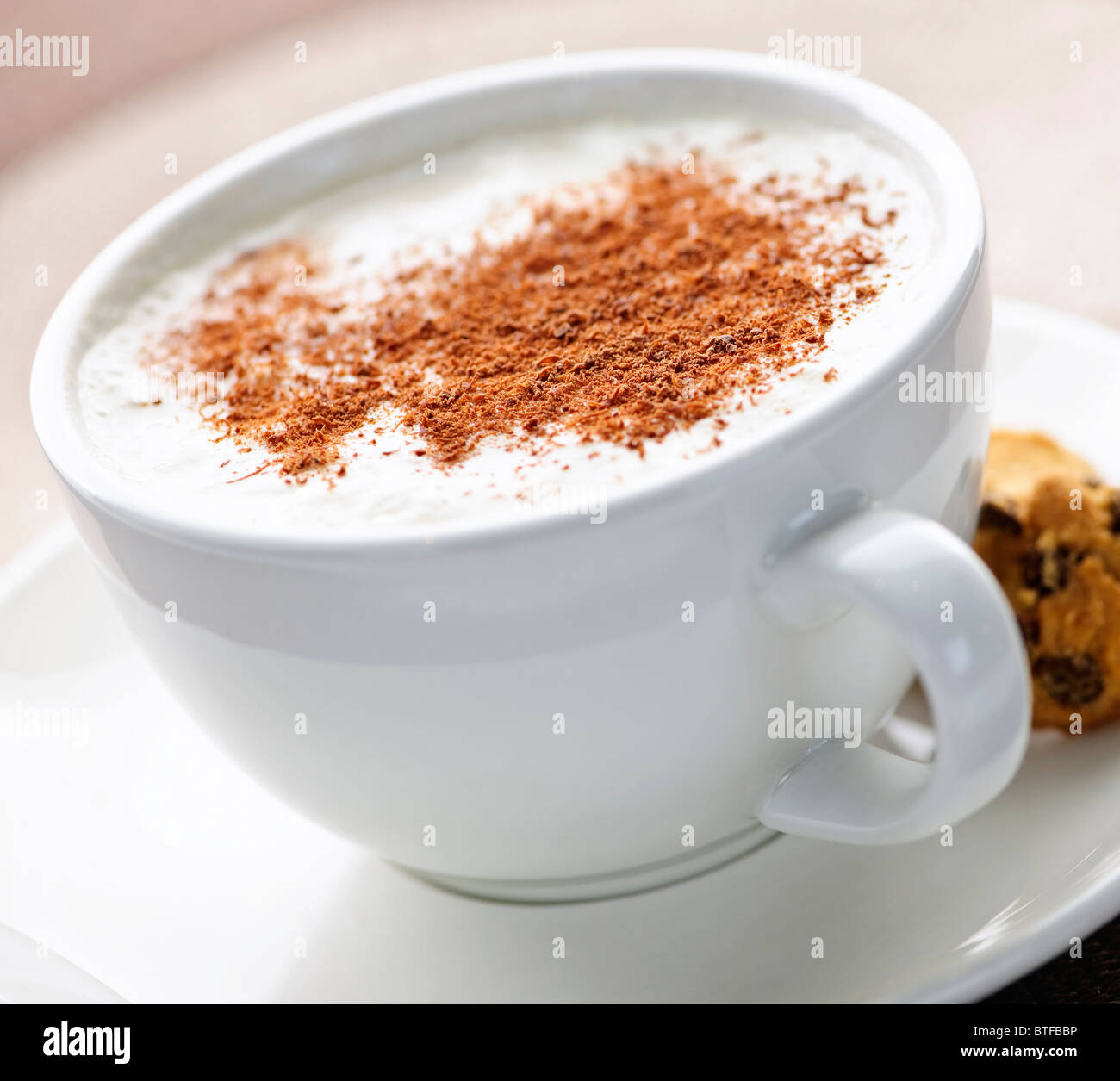Cappuccino or latte coffee in cup with frothed milk and cookies Stock Photo