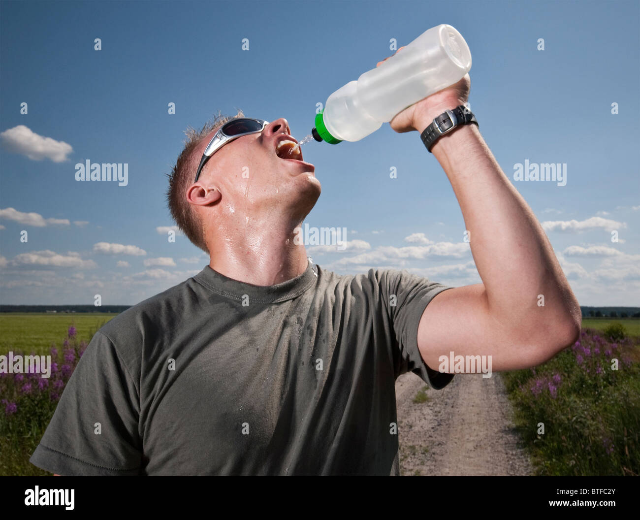 Male athlete drinking water on hot summer day Stock Photo Alamy