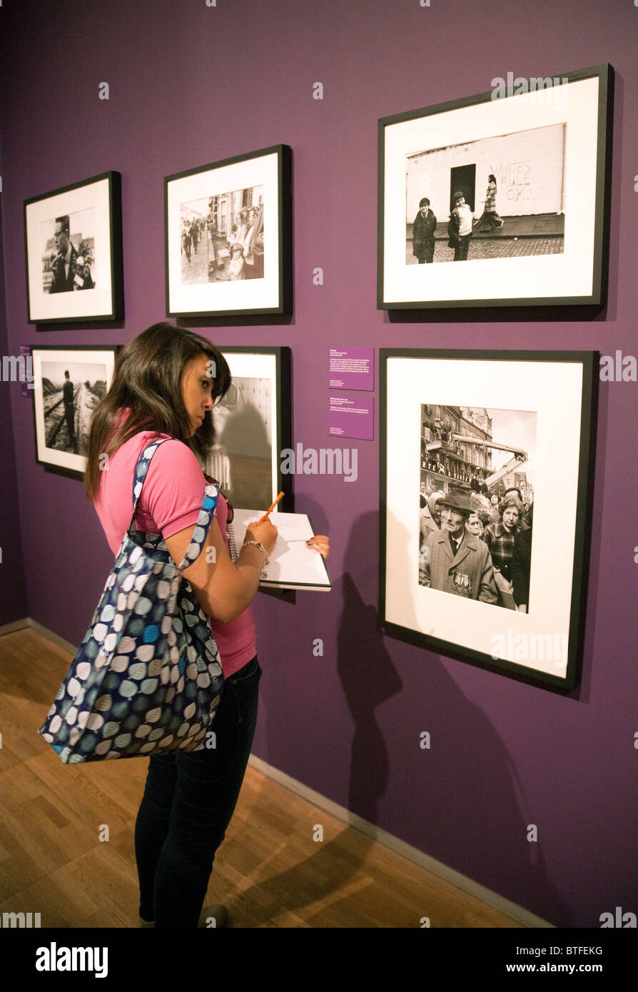 Photography A level student studying a photographic exhibition; the Victoria and Albert Museum, London UK Stock Photo
