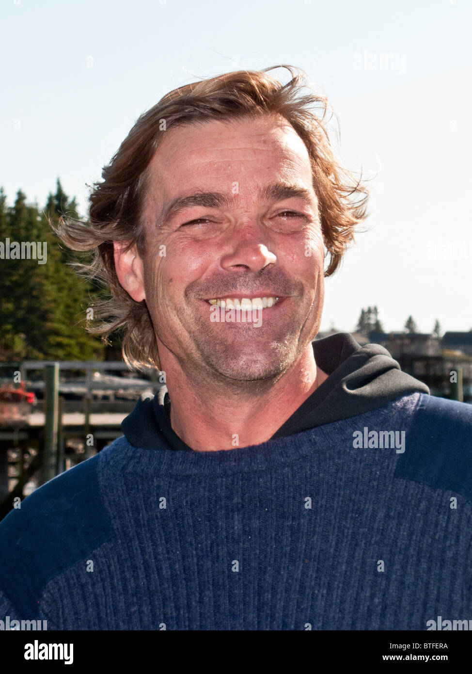 A proud young lobsterman at a pier in Islesford, Maine. Stock Photo