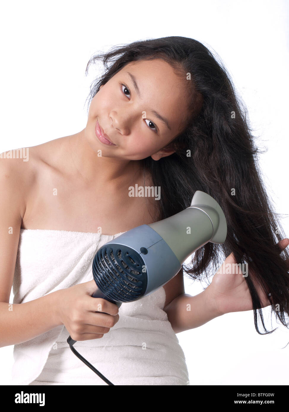 A teenage girl dries her hair Stock Photo - Alamy