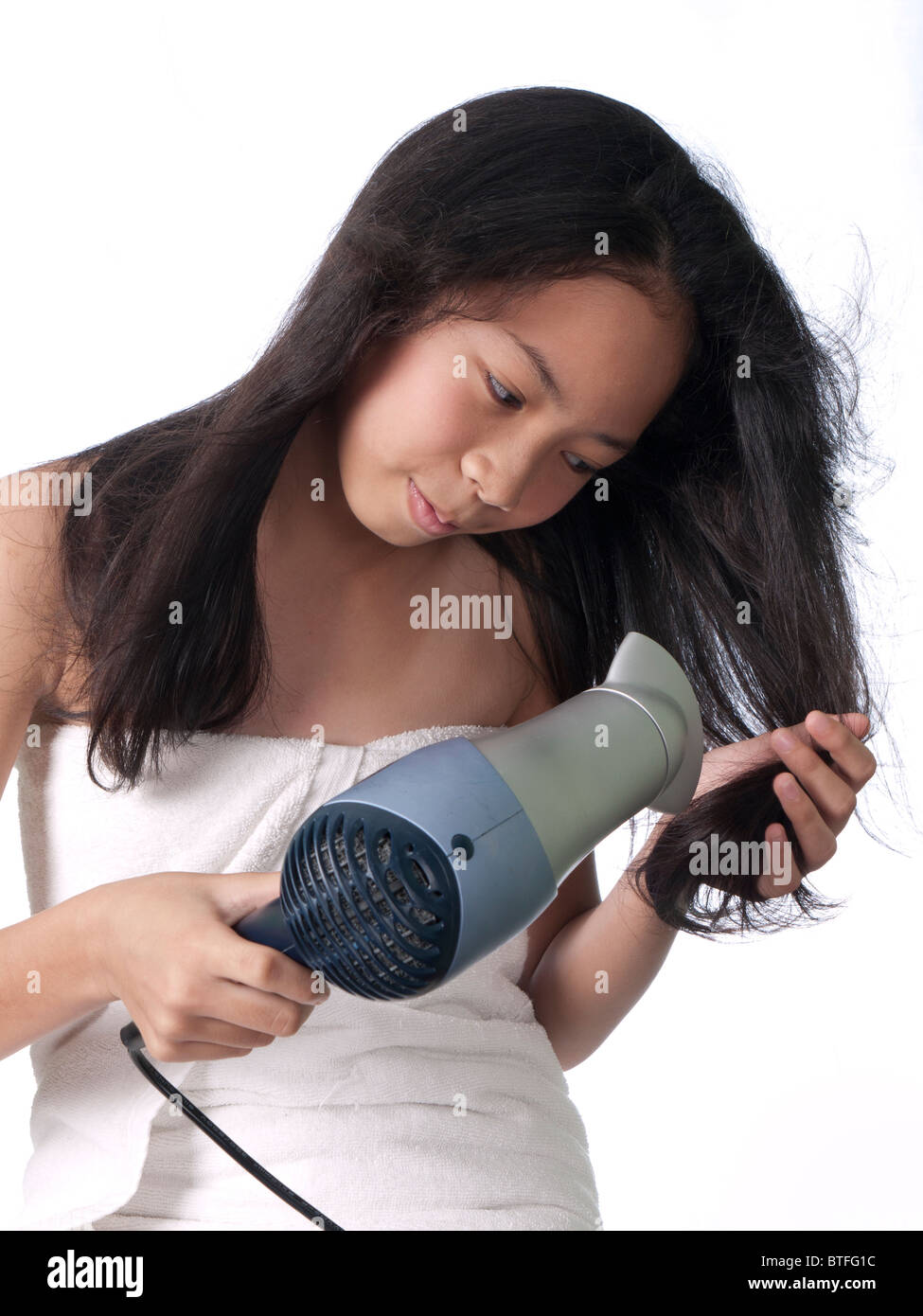 A teenage girl dries her hair Stock Photo - Alamy