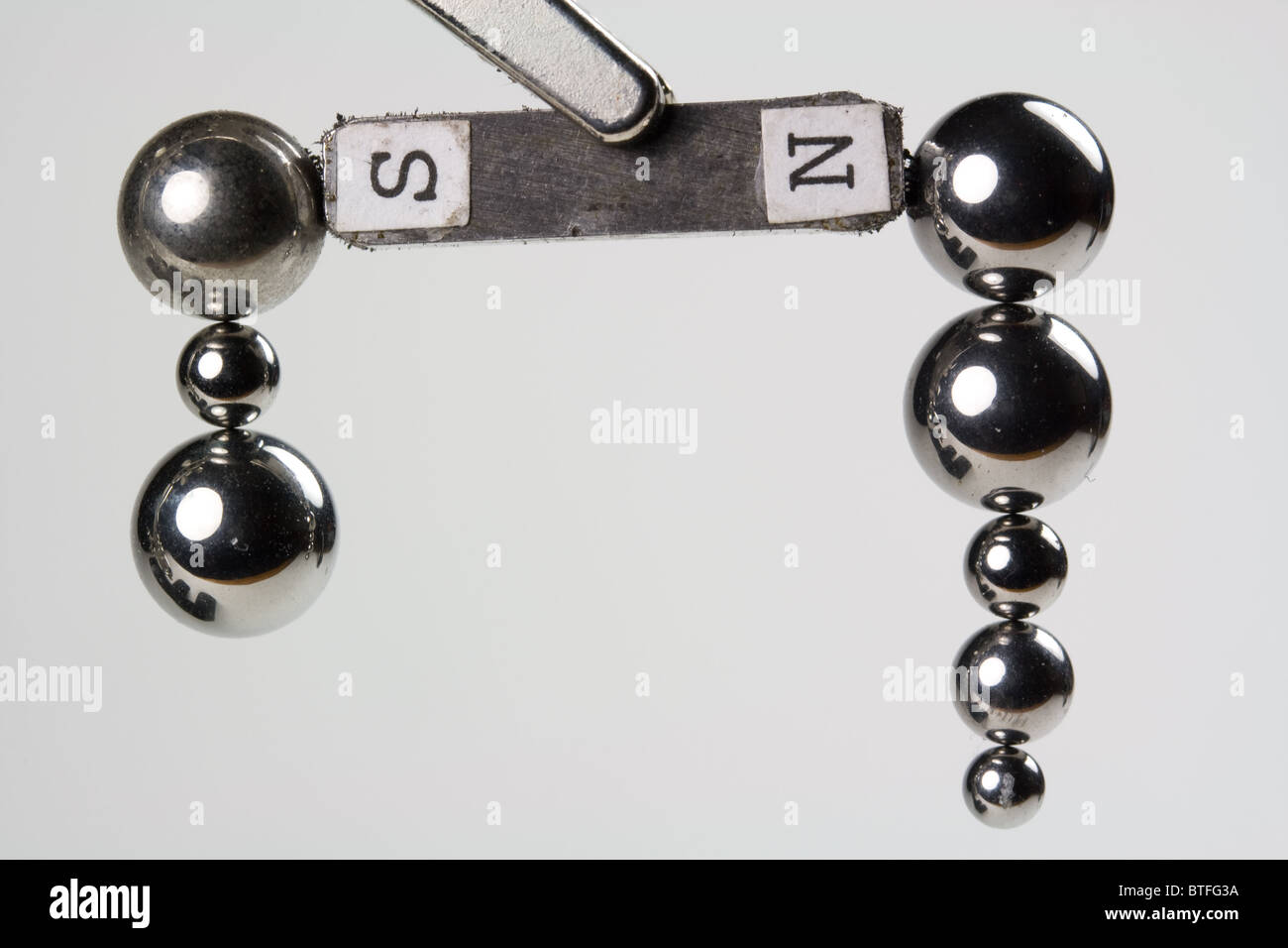 Steel Ball Bearings Attracted to Magnet Stock Photo