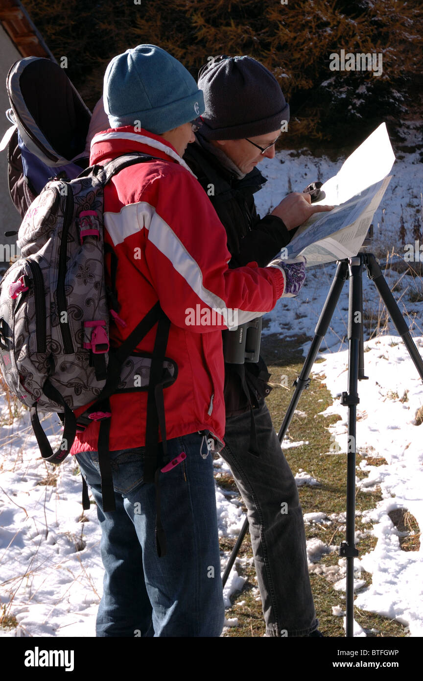 Hikers check their map in Val Trupchun in Switzerland's National Park, Graubunden Stock Photo