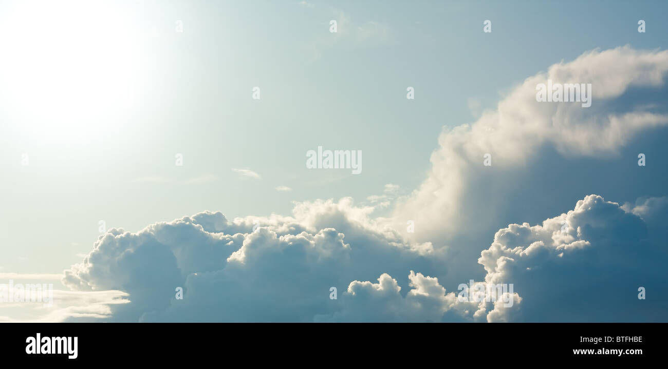 Close shiny clouds on blue sky background Stock Photo - Alamy