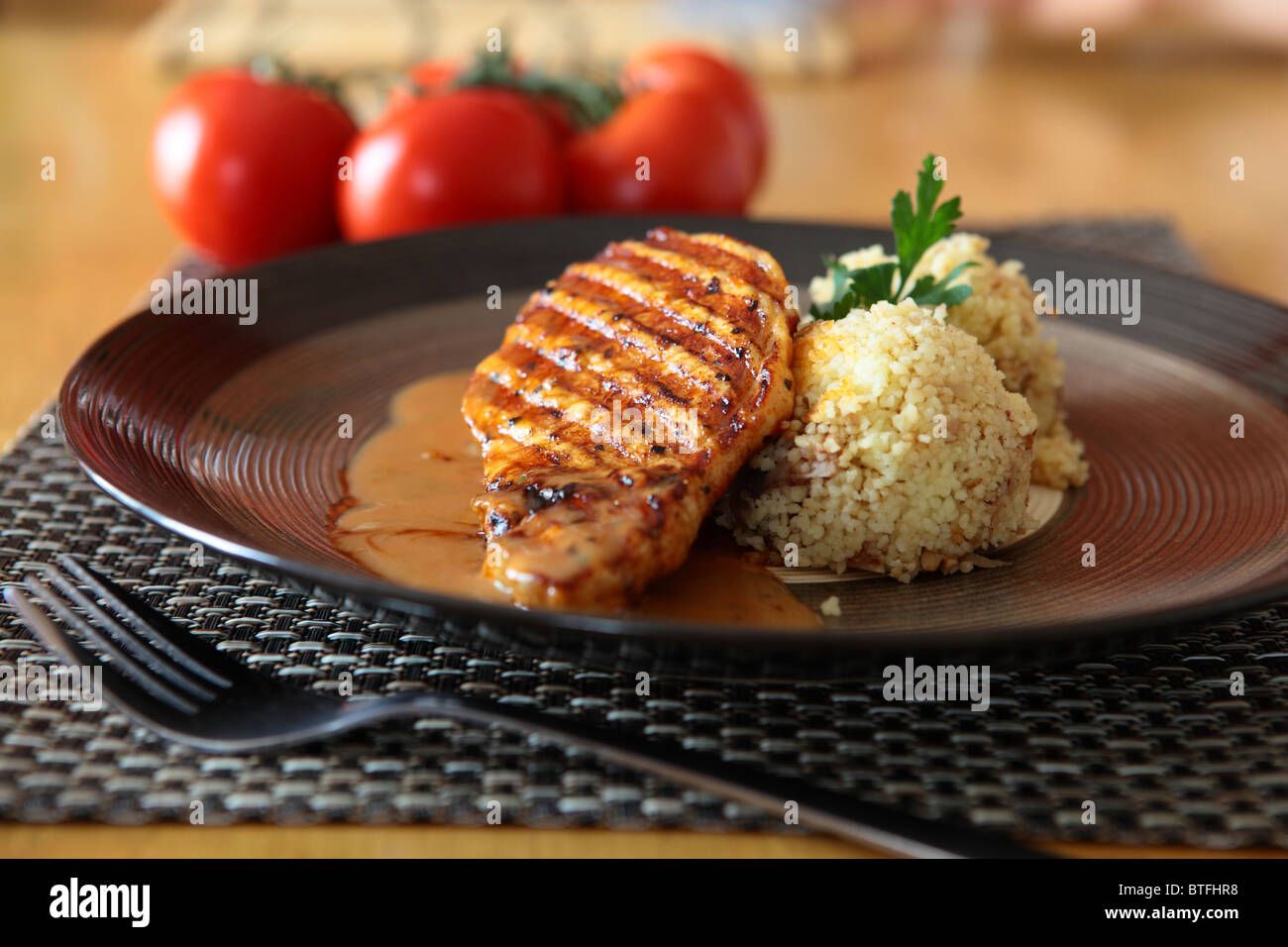 Pork With Pepper Sauce and Cous-Cous On a Plate Stock Photo