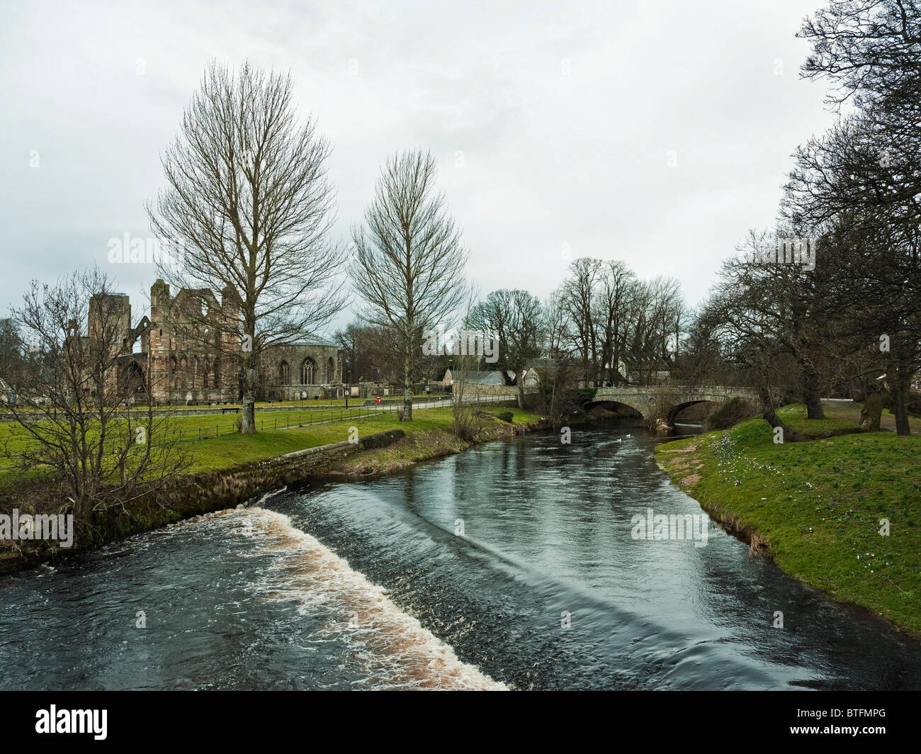 Elgin Cathedral viewed across the  weir on the river Lossie, Elgin, Scotland, UK Stock Photo