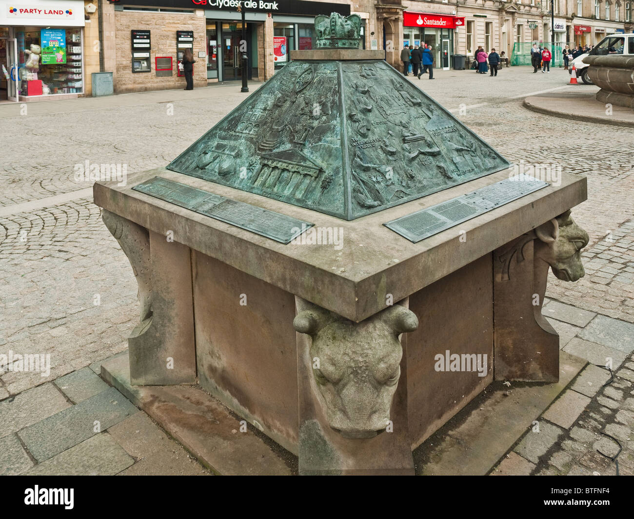 Stone and bronze monument with panels depicting the history of Elgin, High Street, Elgin, Scotland, UK Stock Photo