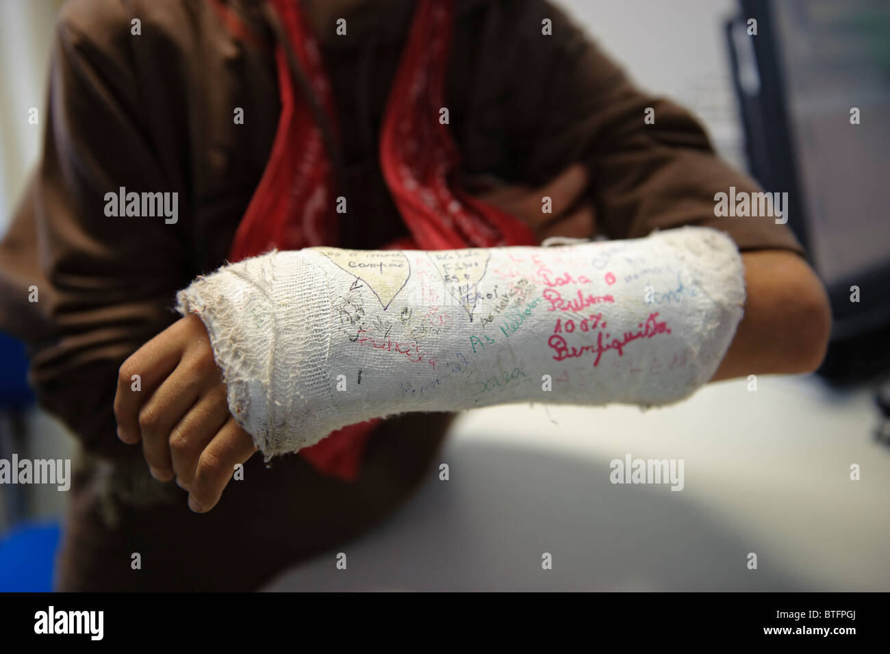 Broken arm in a cast covered with signatures Stock Photo