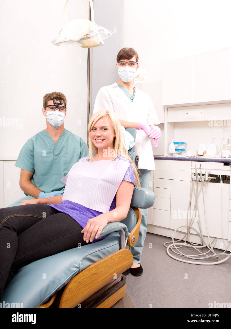 A dentist, assistant and patient in a dental clinic Stock Photo