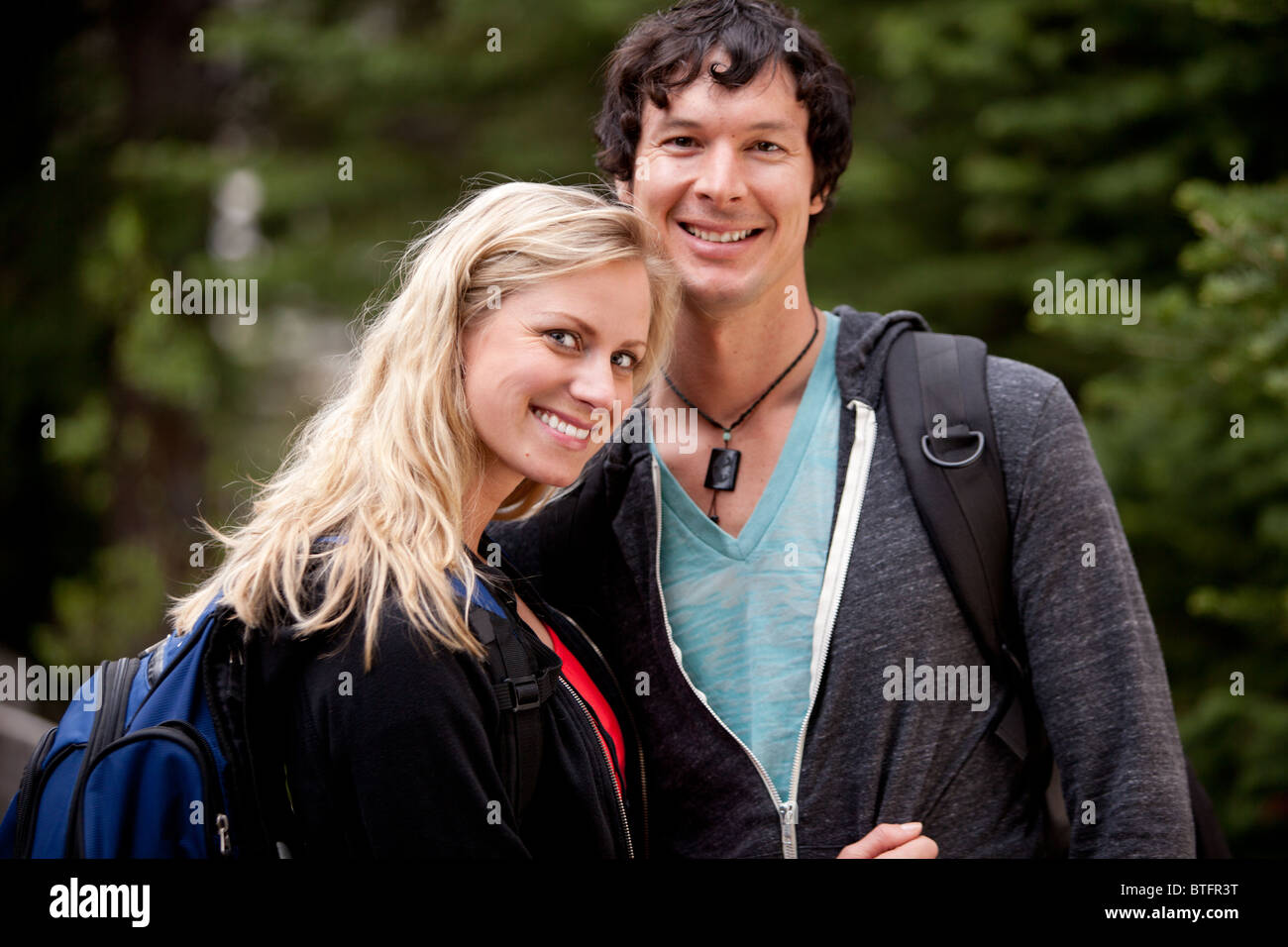 A happy couple hiking in the forest Stock Photo - Alamy