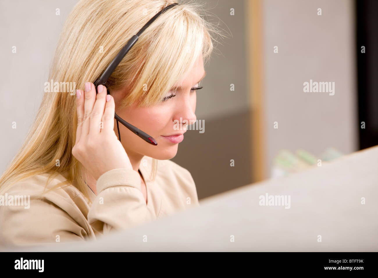 A receptionist talking on the phone with a headset Stock Photo Alamy