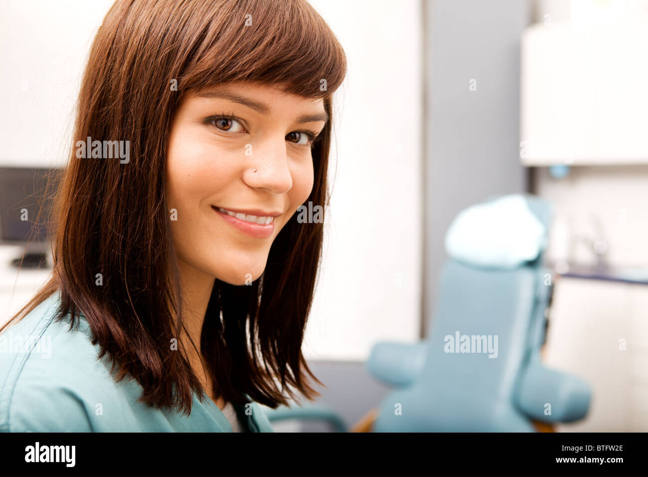 A portrait of a dental hygienist in front of a dental chair Stock Photo