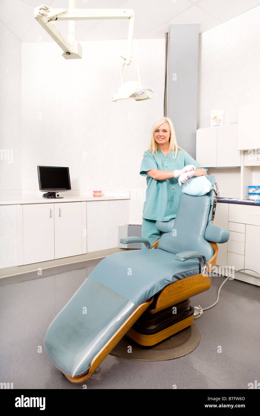 A happy assistant / hygienist standing by a dental chair Stock Photo
