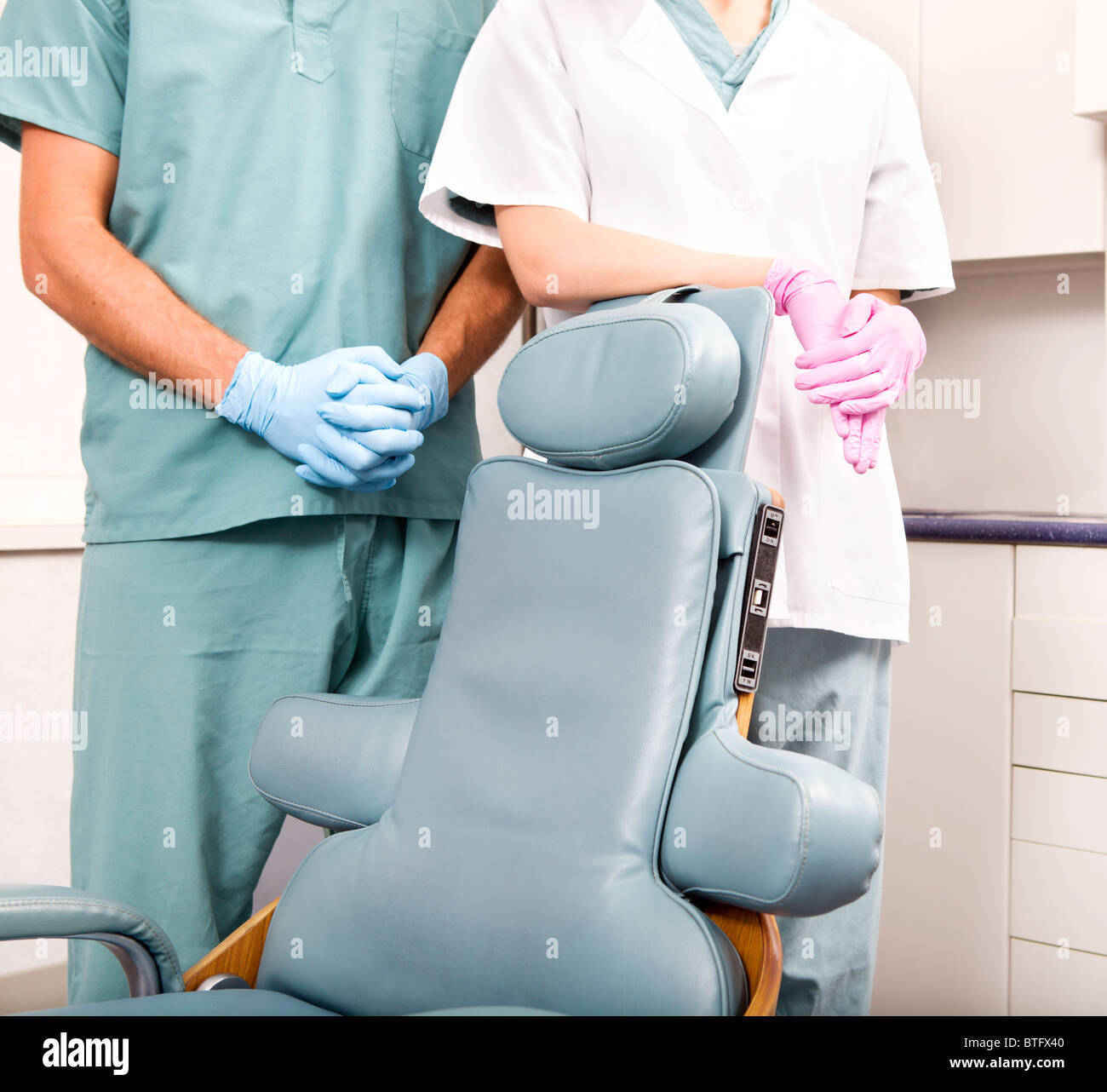 A dentist and assistant at a dental clinic standing by a dental chair Stock Photo