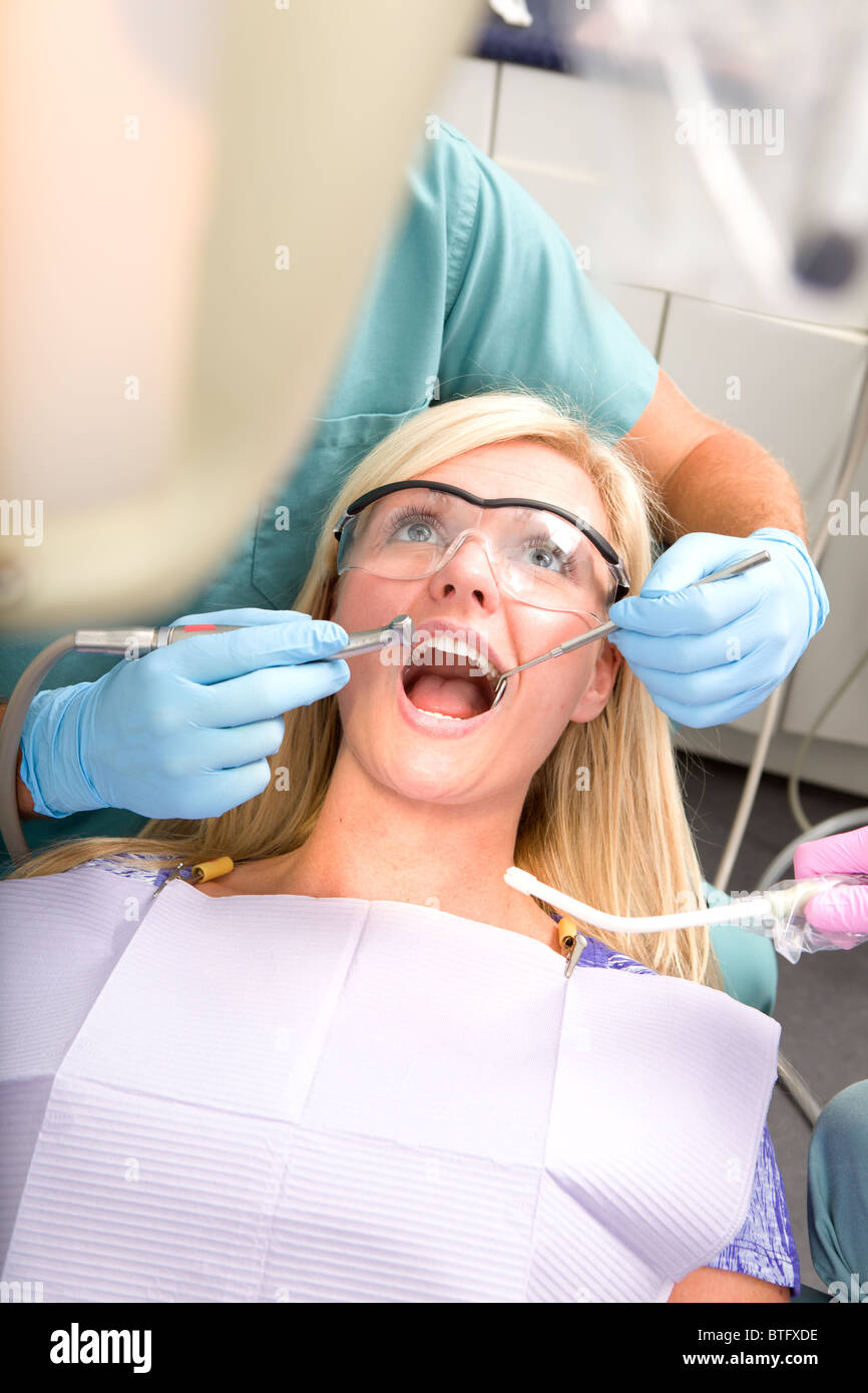A patient at the dentist having their teeth worked on Stock Photo