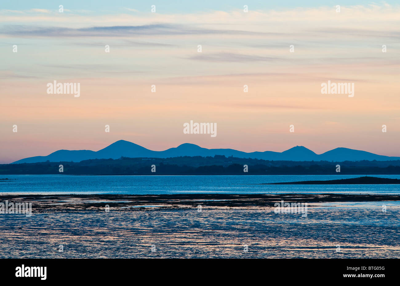 The Mourne Mountains at sunset, seen from Mount Stewart on the Ards Peninsula  looking across Strangford Lough, Northern Ireland Stock Photo