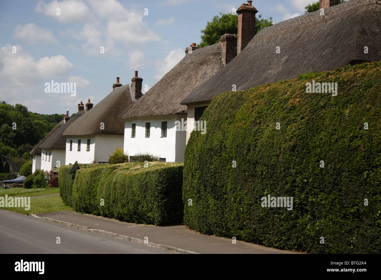 A row of thatched houses in Milton Abbas Dorset England Stock Photo Alamy