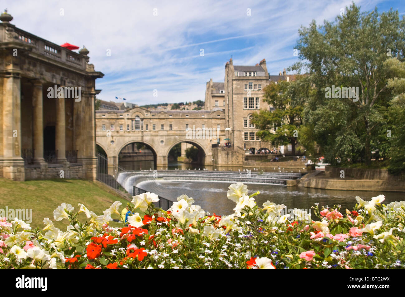 Horizontal wide angle of the grade 1 listed Pulteney Bridge crossing the river Avon in the centre of Bath on a sunny day. Stock Photo