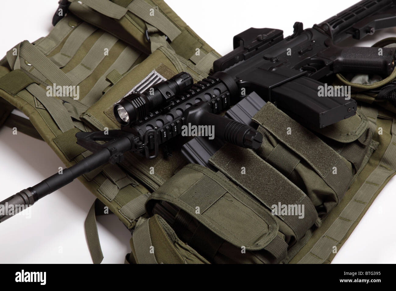 US military concept. Tactical vest and assault rifle close-up. Studio shot. Stock Photo
