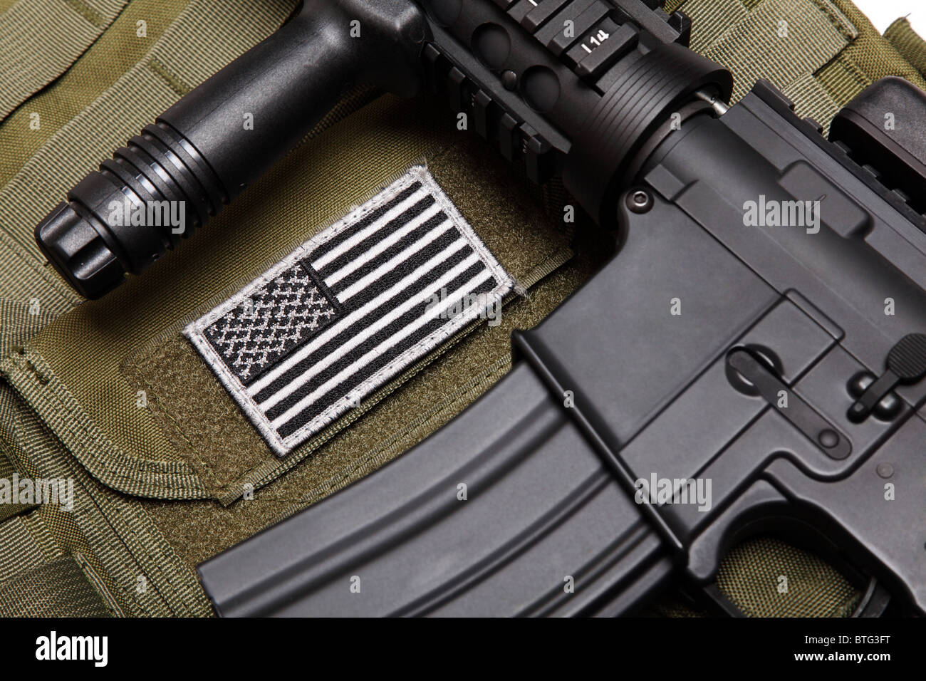 US military concept. Tactical vest with U.S. battle flag and assault rifle  with tactical grip close-up. Studio shot Stock Photo - Alamy