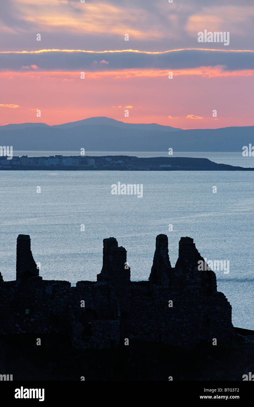 Dunluce Castle, County Antrim, Ulster, Northern Ireland, UK. Silhouette of ruins at sunset. Stock Photo