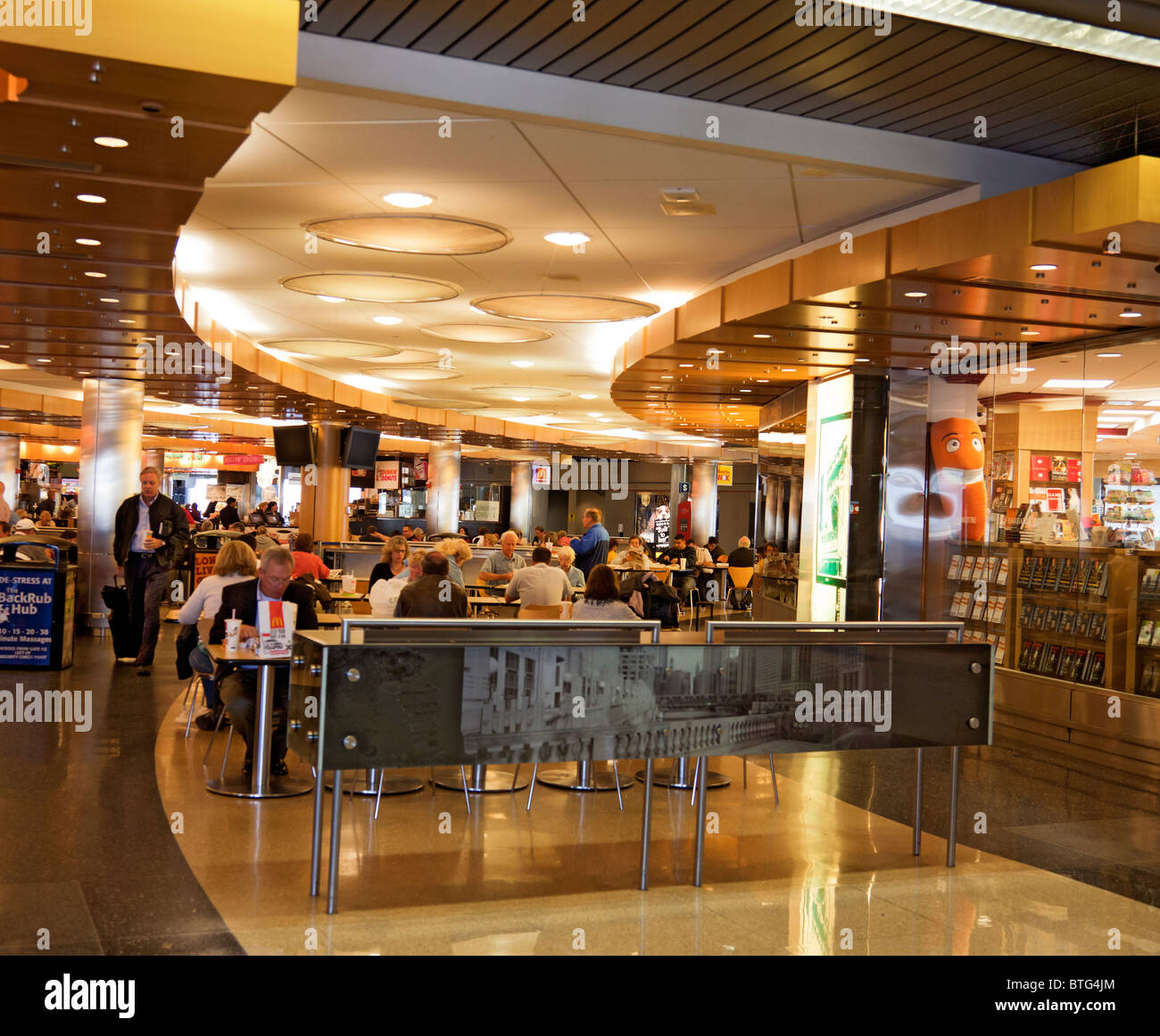 Air passengers eating fast food at a concourse food outlet while