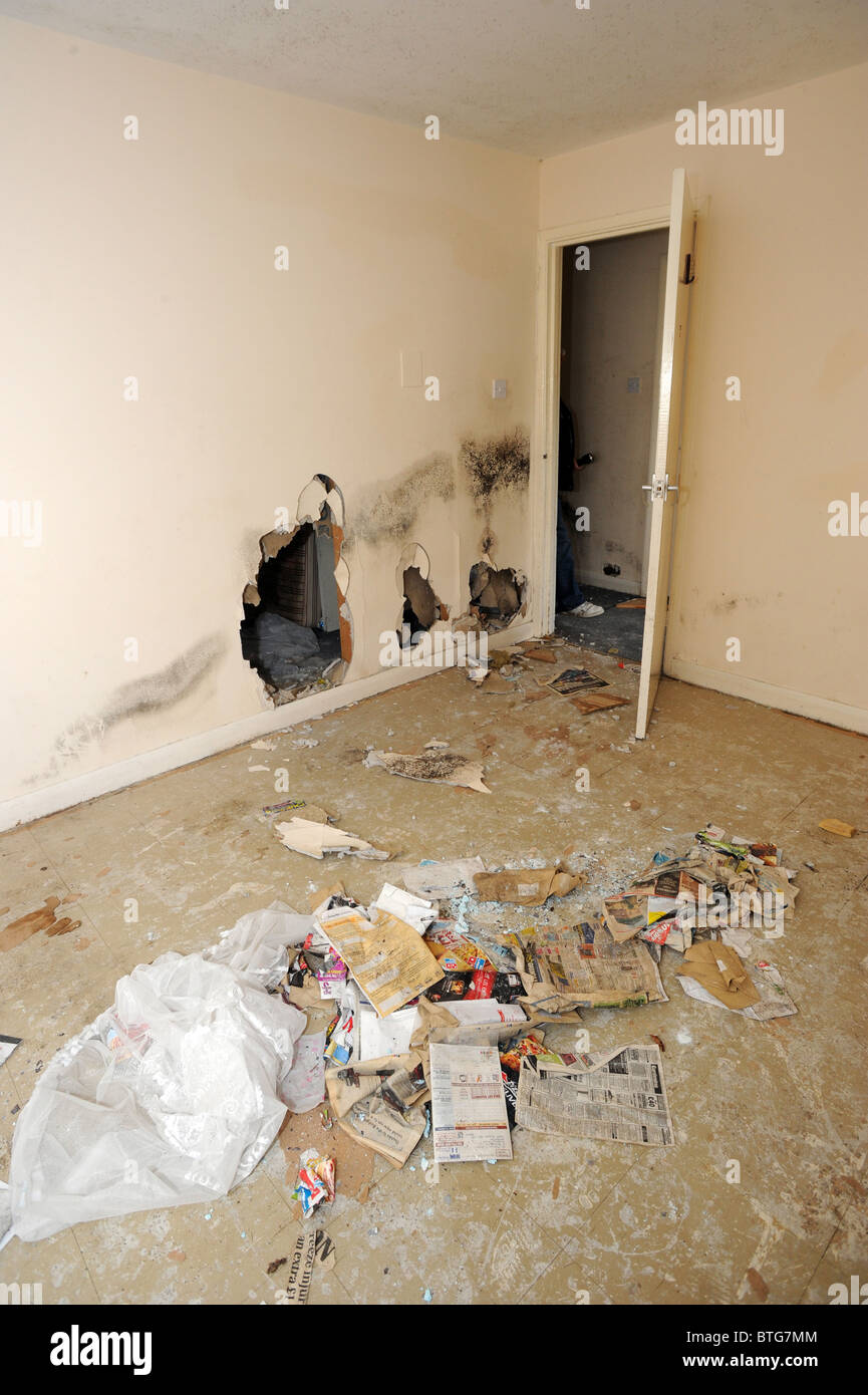 Damage left to a large council owned house after illegal squatters wrecked it Stock Photo