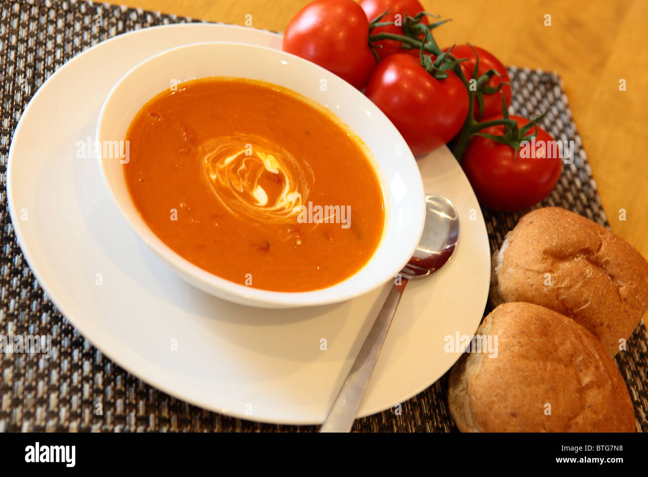 Tomato Soup with Bread and Tomatoes on the Side Stock Photo