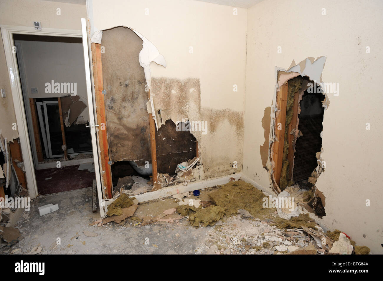 Damage left to a large council owned house after illegal squatters wrecked it Stock Photo