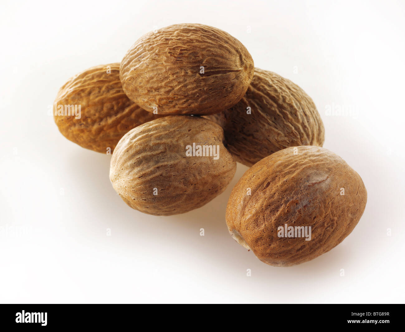 Wole Nutmegs  composed arrangement isolated against a white background Stock Photo