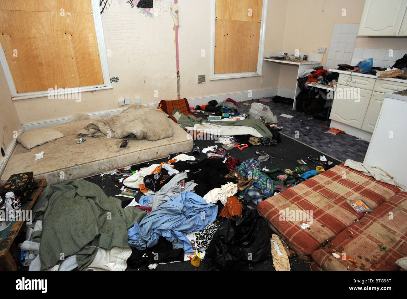 Damage left to a large council owned house after illegal squatters wrecked it Stock Photo